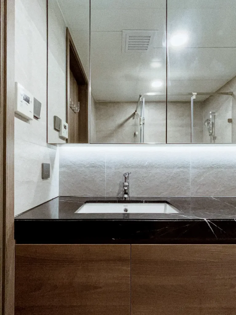 Caribbean Coast bathroom design with black marble top and walnut cabinet