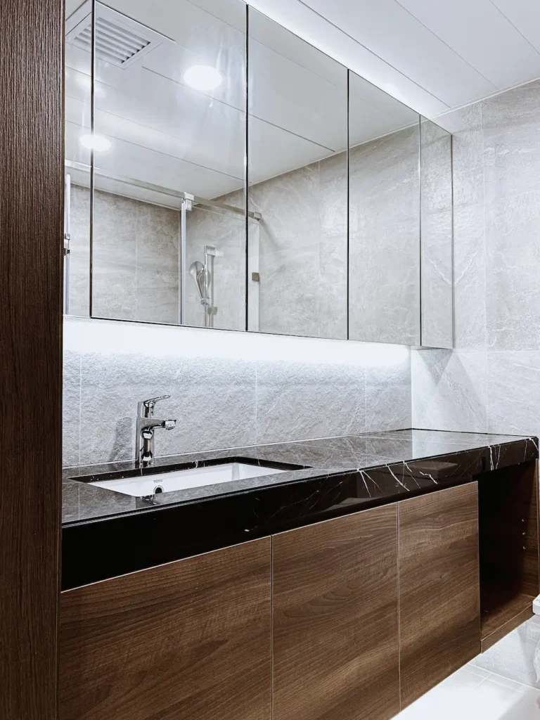 Caribbean Coast bathroom design with black marble top and walnut cabinet