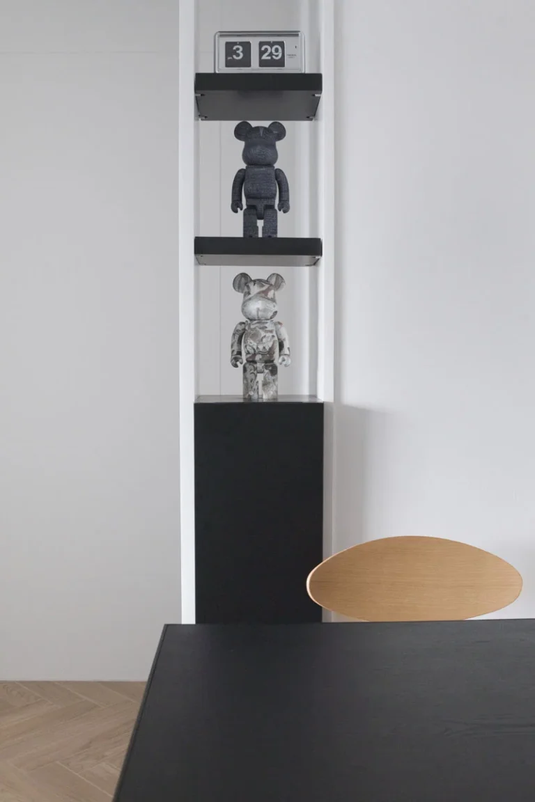 black cabinet with bearbrick figure