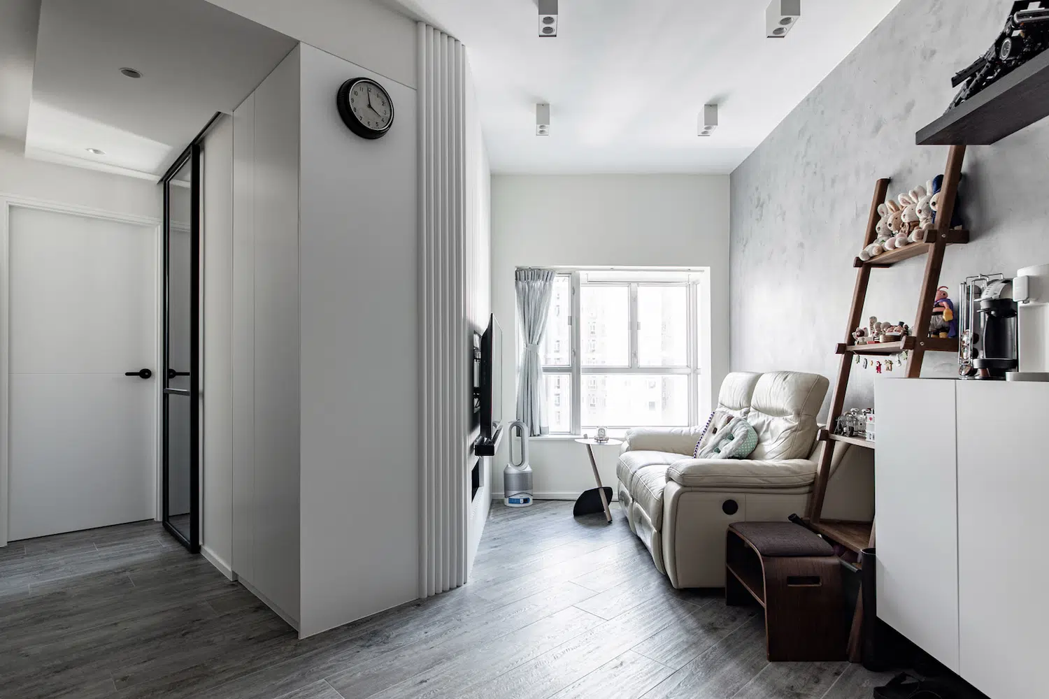 Industrial style living room design with concrete wall and white wall storage