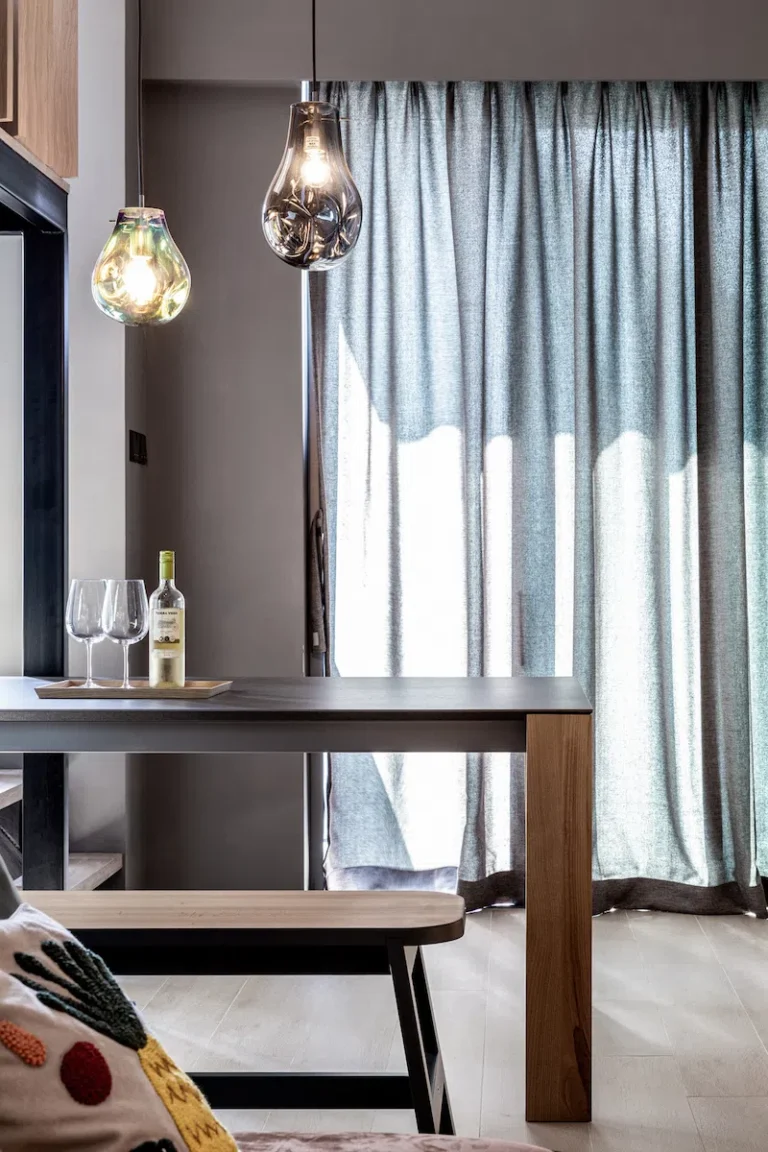 dining area featuring a concrete table with two glass lamps