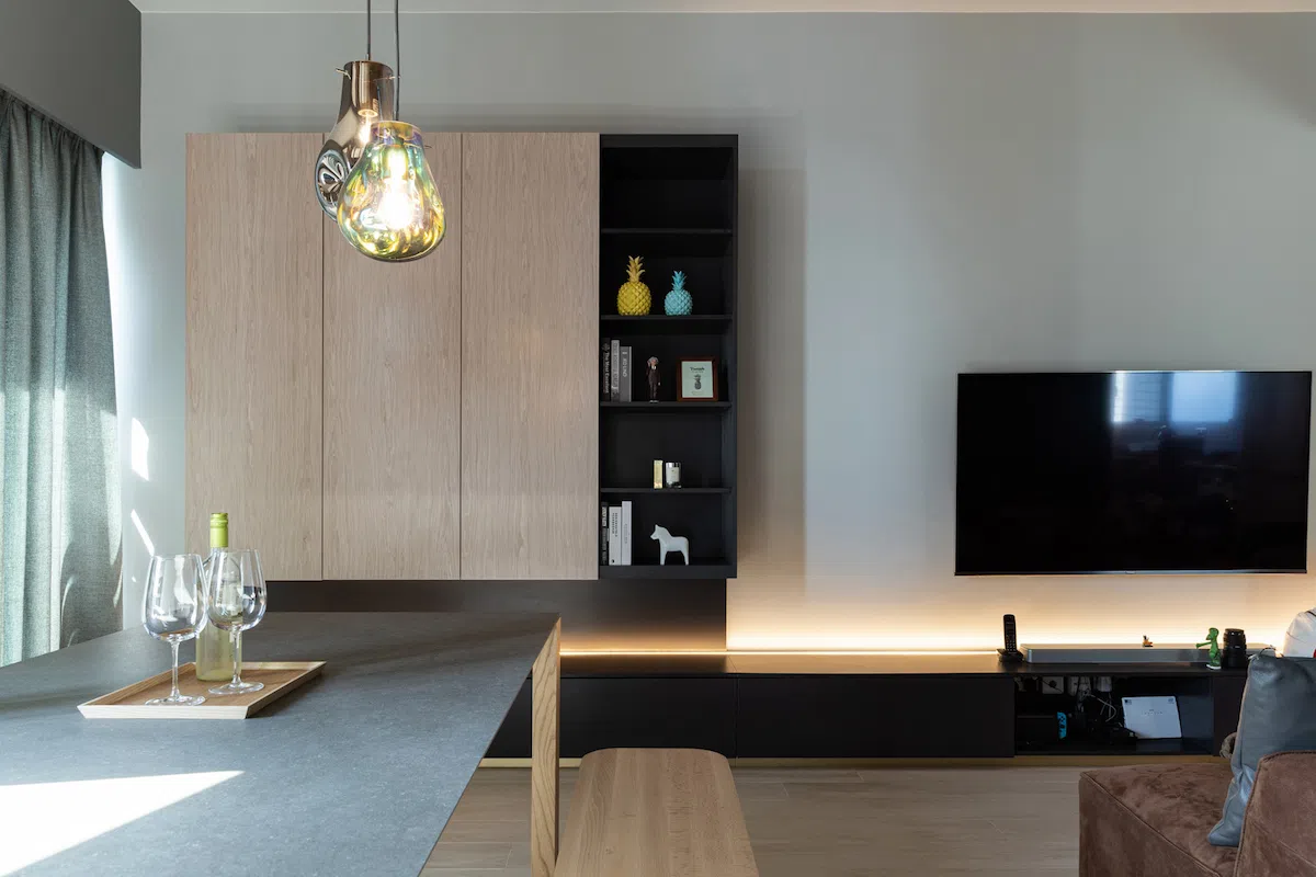 larvotto design with a sleek black TV cabinet on an oak floor