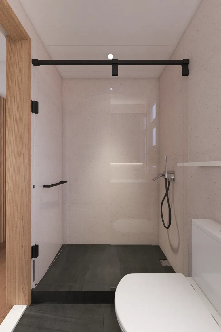 bathroom design with dark grey tiles and glass shower panel